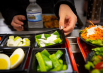  Student picking up veggies
